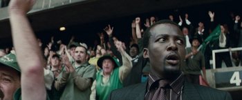 Movie still from “Invictus” (2009), directed by Clint Eastwood – A group of people standing in front of a crowd; Close Up shot, Low angle