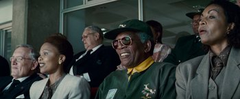 Movie still from “Invictus” (2009), directed by Clint Eastwood – An older man wearing a hat and sunglasses; Close Up shot, Low angle