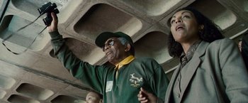 Movie still from “Invictus” (2009), directed by Clint Eastwood – An older man wearing a green and yellow shirt; Medium shot, Low angle