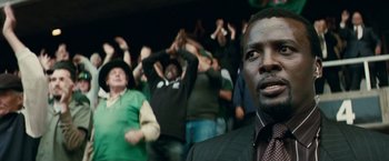 Movie still from “Invictus” (2009), directed by Clint Eastwood – A group of people standing in front of a crowd; Close Up shot, Low angle