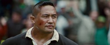 Movie still from “Invictus” (2009), directed by Clint Eastwood – A person with a shaved head; Close Up shot, Low angle