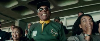 Movie still from “Invictus” (2009), directed by Clint Eastwood – An older man wearing a green and yellow shirt; Close Up shot, Low angle