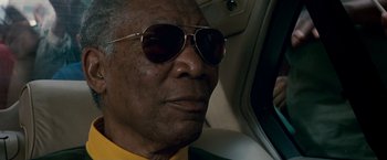 Movie still from “Invictus” (2009), directed by Clint Eastwood – An older man wearing a yellow shirt and sunglasses; Close Up shot, Low angle
