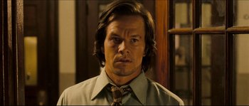 Movie still from “Invincible” (2006), directed by Ericson Core – A person wearing a shirt and a tie; Close Up shot, Over the shoulder angle