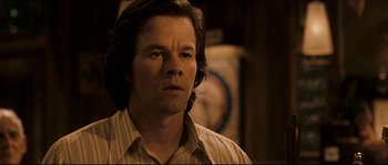 Movie still from “Invincible” (2006), directed by Ericson Core – A person with long hair; Close Up shot, Over the shoulder angle