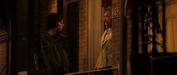 Movie still from “Invincible” (2006), directed by Ericson Core – Two men standing in front of a brick building; Medium shot, Over the shoulder angle