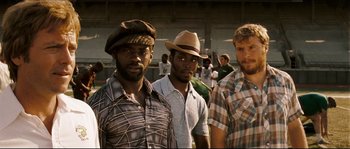 Movie still from “Invincible” (2006), directed by Ericson Core – A group of men standing next to each other; Medium shot, Low angle