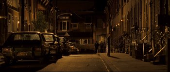 Movie still from “Invincible” (2006), directed by Ericson Core – A couple of cars parked on the side of a street; Extreme Wide shot, High angle