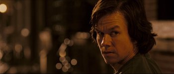 Movie still from “Invincible” (2006), directed by Ericson Core – A person with a blurry background; Close Up shot, Over the shoulder angle