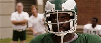 Movie still from “Invincible” (2006), directed by Ericson Core – A person wearing a football helmet; Close Up shot, High angle