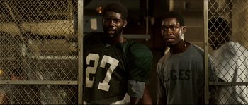 Movie still from “Invincible” (2006), directed by Ericson Core – Two football players standing next to each other; Close Up shot, Low angle