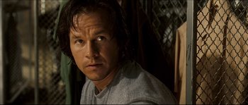 Movie still from “Invincible” (2006), directed by Ericson Core – A person wearing a gray shirt; Close Up shot, Over the shoulder angle