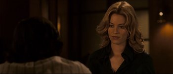 Movie still from “Invincible” (2006), directed by Ericson Core – A woman in a black shirt is sitting in front of a man; Close Up shot, Over the shoulder angle