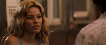 Movie still from “Invincible” (2006), directed by Ericson Core – A woman with blonde hair sitting in front of a window; Close Up shot, Over the shoulder angle