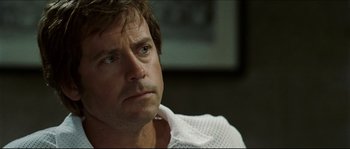 Movie still from “Invincible” (2006), directed by Ericson Core – A person wearing a white shirt; Close Up shot, Over the shoulder angle