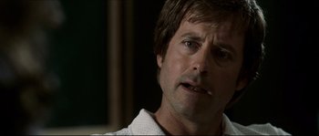 Movie still from “Invincible” (2006), directed by Ericson Core – A man's face in a dark room; Close Up shot, Over the shoulder angle
