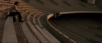 Movie still from “Invincible” (2006), directed by Ericson Core – An empty stadium is shown with no spectators; Extreme Wide shot, High angle