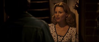 Movie still from “Invincible” (2006), directed by Ericson Core – A beautiful woman looking at a man in the mirror; Medium shot, Over the shoulder angle