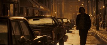 Movie still from “Invincible” (2006), directed by Ericson Core – A row of parked cars on a city street at night; Wide shot, Over the shoulder angle