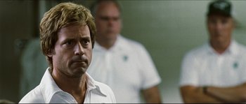 Movie still from “Invincible” (2006), directed by Ericson Core – A man in a white shirt is standing next to another man in a white shirt; Close Up shot, Over the shoulder angle