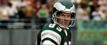 Movie still from “Invincible” (2006), directed by Ericson Core – A football player wearing a helmet; Close Up shot, Overhead angle