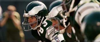Movie still from “Invincible” (2006), directed by Ericson Core – A football player wearing a helmet; Close Up shot, Overhead angle
