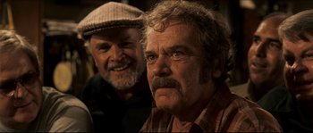 Movie still from “Invincible” (2006), directed by Ericson Core – Two older men are posing for a picture; Close Up shot, Over the shoulder angle