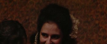 Movie still from “Invisible Life” (2019), directed by Karim Aïnouz – A person wearing a pearl necklace; Close Up shot, High angle