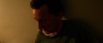 Movie still from “Irreversible” (2002), directed by Gaspar Noé – A person looking down at a wall; Close Up shot, High angle