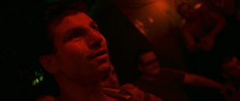 Movie still from “Irreversible” (2002), directed by Gaspar Noé – A man is looking into the distance in a dark room; Close Up shot, Low angle