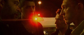 Movie still from “Irreversible” (2002), directed by Gaspar Noé – Two men standing next to each other in the dark; Close Up shot, Low angle