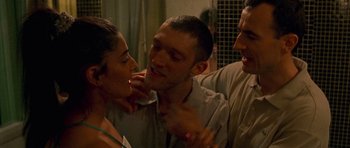 Movie still from “Irreversible” (2002), directed by Gaspar Noé – Two men and a woman in a room; Close Up shot, Over the shoulder angle