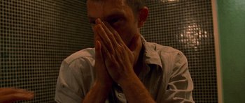 Movie still from “Irreversible” (2002), directed by Gaspar Noé – A man with his hands over his face; Extreme Close Up shot, High angle