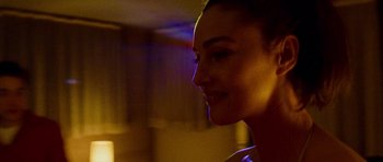 Movie still from “Irreversible” (2002), directed by Gaspar Noé – A woman's face in the dark; Close Up shot, Over the shoulder angle