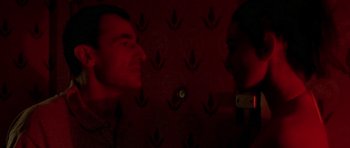 Movie still from “Irreversible” (2002), directed by Gaspar Noé – Two men standing next to each other in a dark room; Close Up shot, Low angle