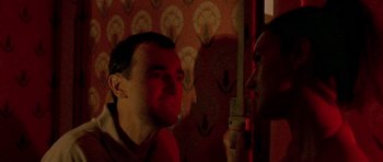Movie still from “Irreversible” (2002), directed by Gaspar Noé – A man and a woman are talking in a room; Close Up shot, Over the shoulder angle