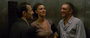 Movie still from “Irreversible” (2002), directed by Gaspar Noé – Three people standing next to each other in an elevator; Close Up shot, Low angle