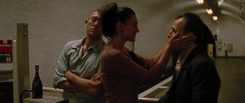 Movie still from “Irreversible” (2002), directed by Gaspar Noé – A man and a woman standing next to each other in a room; Medium shot, Over the shoulder angle