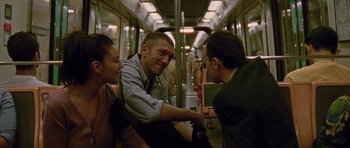 Movie still from “Irreversible” (2002), directed by Gaspar Noé – A man and two women sitting on a subway train; Medium shot, Over the shoulder angle