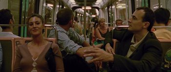 Movie still from “Irreversible” (2002), directed by Gaspar Noé – A group of people sitting on a train; Medium shot, Over the shoulder angle