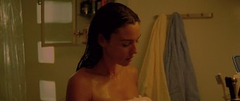 Movie still from “Irreversible” (2002), directed by Gaspar Noé – A woman in the bathroom taking a shower; Close Up shot, Over the shoulder angle