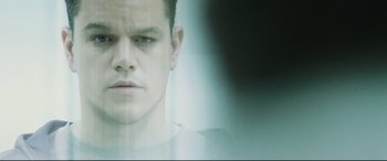 Movie still from “Jason Bourne” (2016), directed by Paul Greengrass – A man's face in front of a glass window; Close Up shot, Low angle