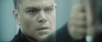 Movie still from “Jason Bourne” (2016), directed by Paul Greengrass – A man's face as he stares out of a window; Close Up shot, Over the shoulder angle