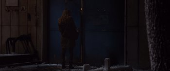 Movie still from “Jason Bourne” (2016), directed by Paul Greengrass – A woman standing in front of a window in the dark; Wide shot, Over the shoulder angle