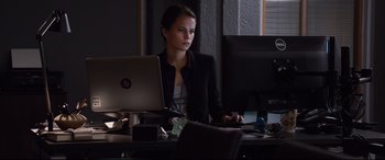 Movie still from “Jason Bourne” (2016), directed by Paul Greengrass – A woman sitting in front of a computer monitor; Medium shot, Over the shoulder angle