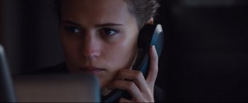 Movie still from “Jason Bourne” (2016), directed by Paul Greengrass – A person talking on a cell phone; Close Up shot, Over the shoulder angle