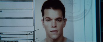 Movie still from “Jason Bourne” (2016), directed by Paul Greengrass – Matt damon's face in a police photo; Close Up shot, Overhead angle