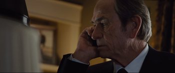 Movie still from “Jason Bourne” (2016), directed by Paul Greengrass – An older man is talking on a cell phone; Close Up shot, Low angle