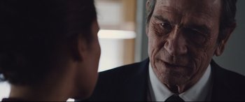 Movie still from “Jason Bourne” (2016), directed by Paul Greengrass – An older man looking at a younger man in a suit; Close Up shot, Over the shoulder angle