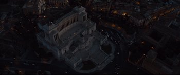 Movie still from “Jason Bourne” (2016), directed by Paul Greengrass – An aerial view of a large building at night time; Extreme Wide shot, High angle